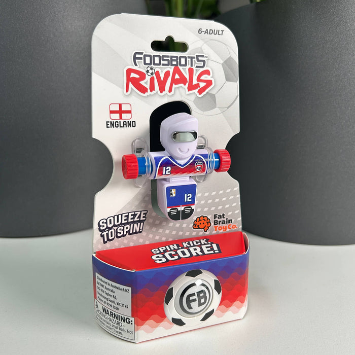 Package of a toy figure with 'Foodsbots Rivals'  OF ENGLAND branding on a gray background