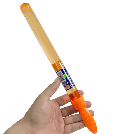 Hand holding a light-up bubble toy bat with an orange handle and clear body on a white background