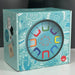 Introduce your little one to rhythm and colour with the Baby Decorative box with colorful letter designs on a blue background