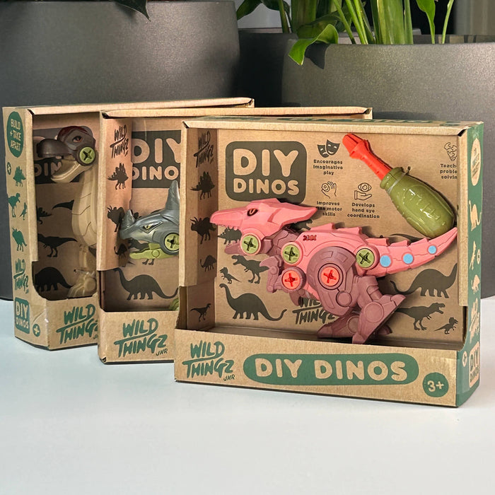 DIY Dino Triceratops Wild Thin Pink dinosaur toy with green weapon in a 'DIY Dinos' box on a light surface.