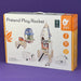 Box of a pretend play rocket set with toy illustrations on a purple background