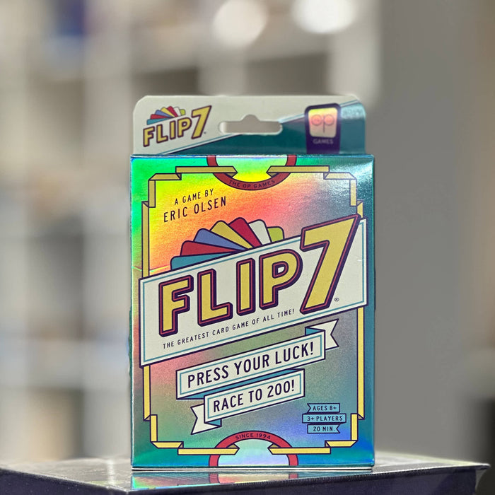 Flip7 card game packaging on a stand with a blurred background