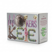 Box of 'Monikers' game with colorful letters and a puffer fish illustration on a blurred background