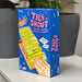 Tilt 'N Shout game box on a surface with plants in the background