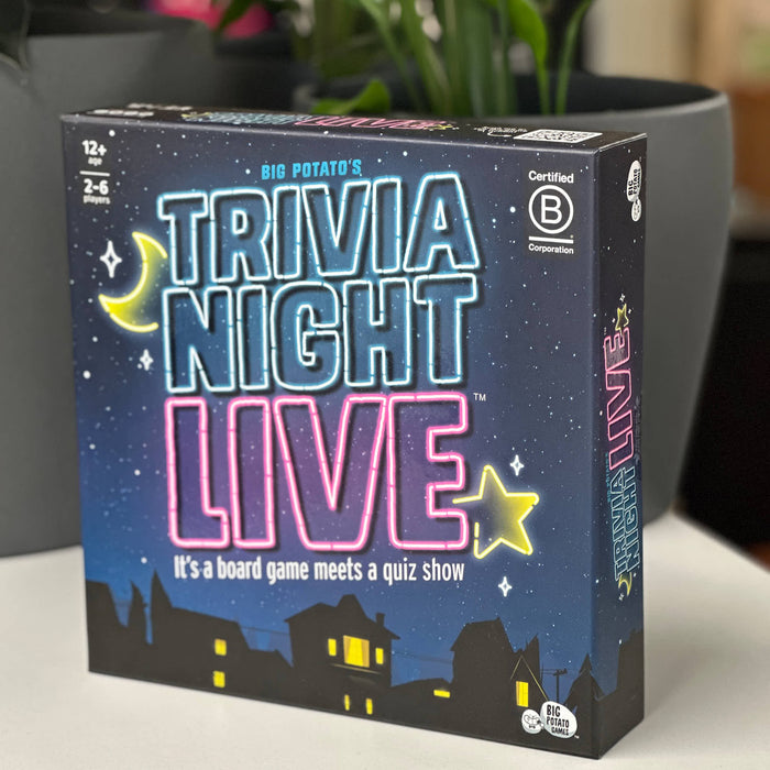 Trivia Night Live board game box on a surface with plants in the background