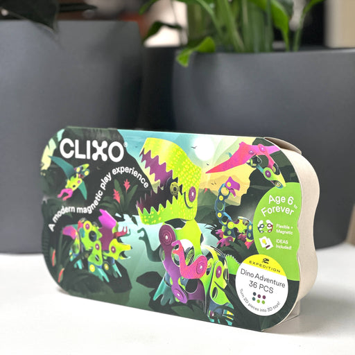 Clixo dinosaur toy set packaging on a surface with a blurred background