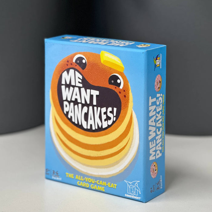 Box of 'Me Want Pancakes!' card game with cartoon pancake design on a gray background