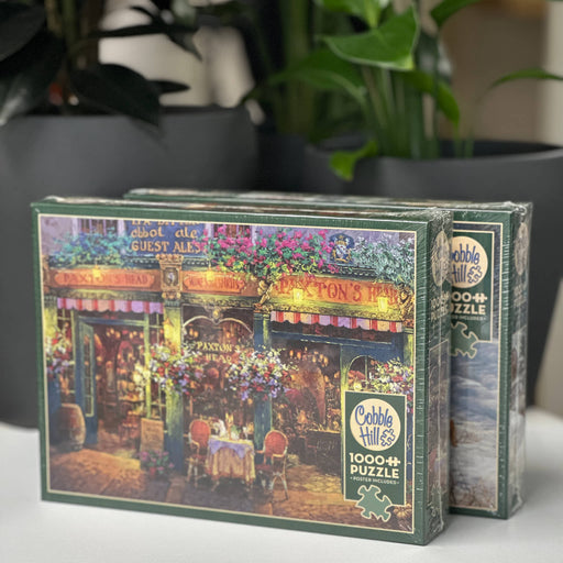 Cobble Hill puzzle box with a colorful scene of a restaurant on a table.