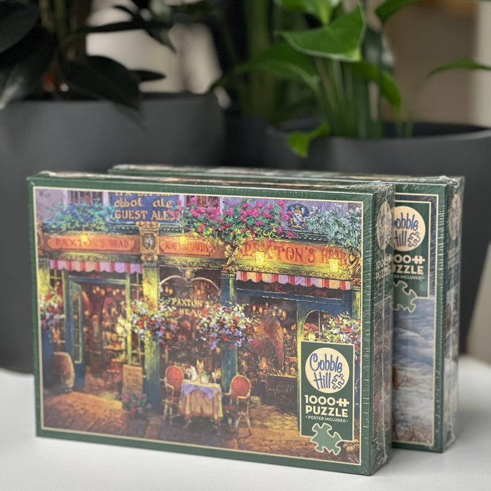 Cobble Hill puzzle box with a colorful scene of a restaurant on a table.