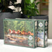 Cobble Hill puzzle box Two Cribbage Hill puzzle boxes with nature-themed artwork on a white surface.