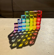 set of plato's cubes translucent Platonic-style cubes arranged in a rainbow gradient 