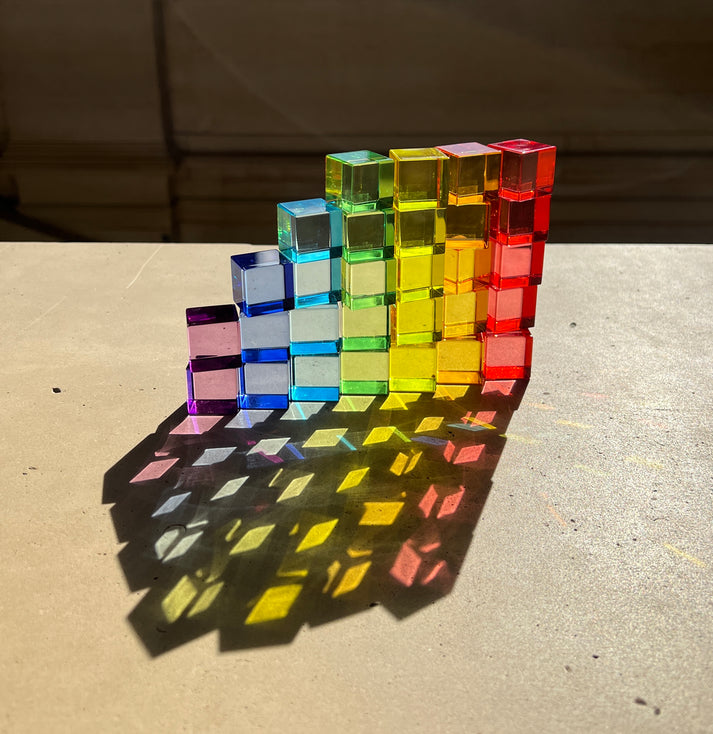 set of plato's cubes translucent Platonic-style cubes arranged in a rainbow gradient 