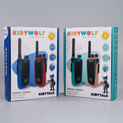 Two retail boxes of KIDYWOLF Kidytalk walkie-talkies shown side by side on a light gray studio background. The left box is blue and features black and red walkie-talkies, while the right box is teal and features black and beige walkie-talkies.