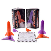 Two colorful rocket-shaped toys with packaging and accessories on a white background