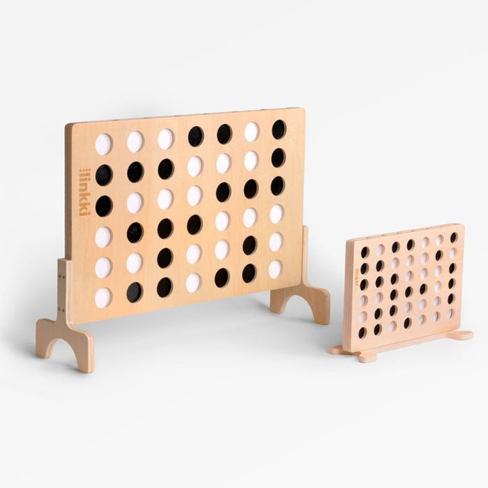 Wooden connect four game set on a white background