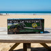 Metal detector toy packaging on a wooden table with a beach background