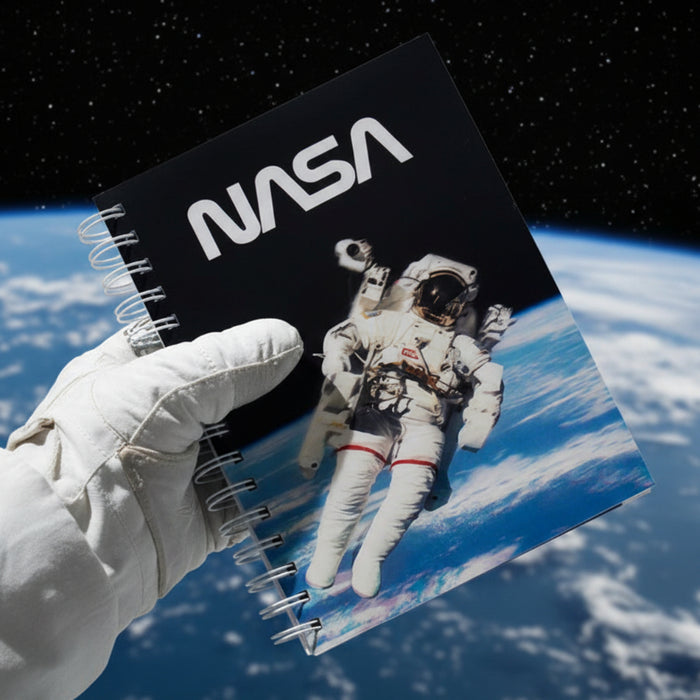 Notebook with NASA logo and astronaut image on a blue background
