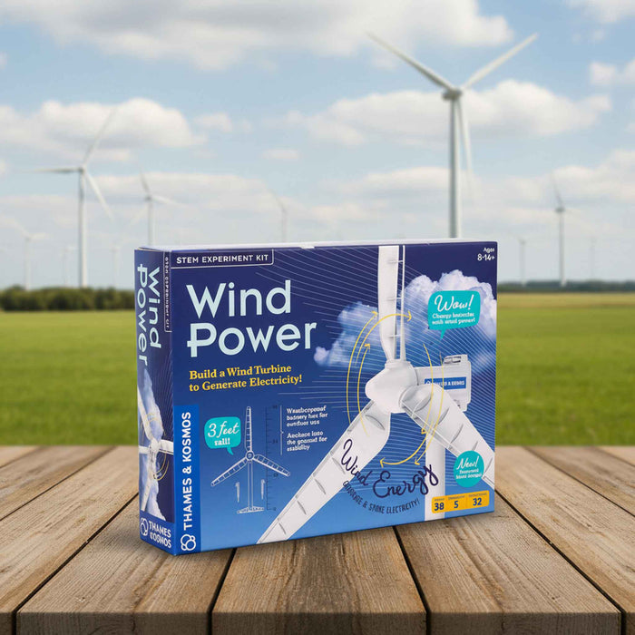 Wind power STEM experiment kit box on a wooden surface with wind turbines in the background
