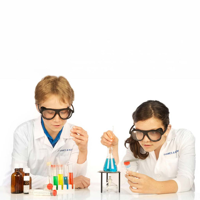 Two children in lab coats conducting a science experiment with beakers and test tubes on a white background.