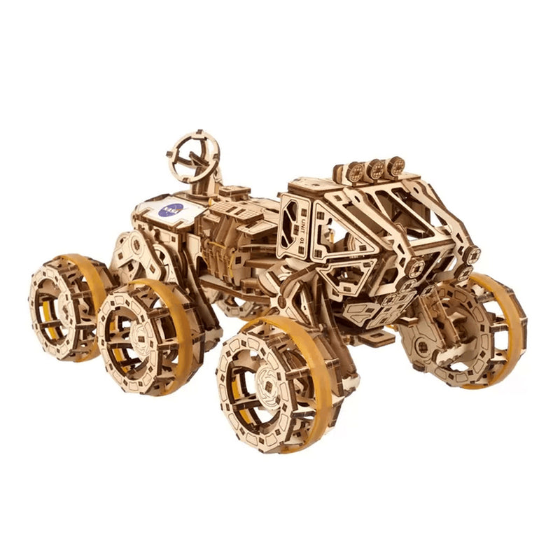 NASA-themed mechanical models packaging on a wooden surface Wooden model tractor kit on a white background