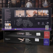 NASA-themed mechanical models packaging on a wooden surface