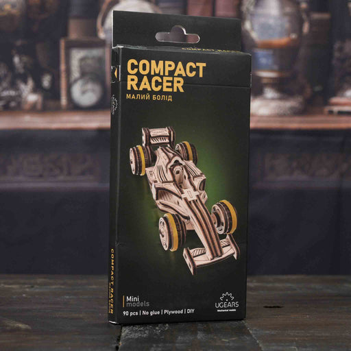 Ugears Compact Racer model packaging on a dark background