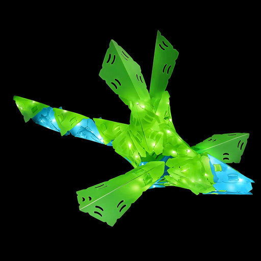 CREATTO dragon 3D puzzle packaging on a table with toys in the background Toy airplane with green and blue lights on a black background