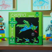CREATTO dragon 3D puzzle packaging on a table with toys in the background