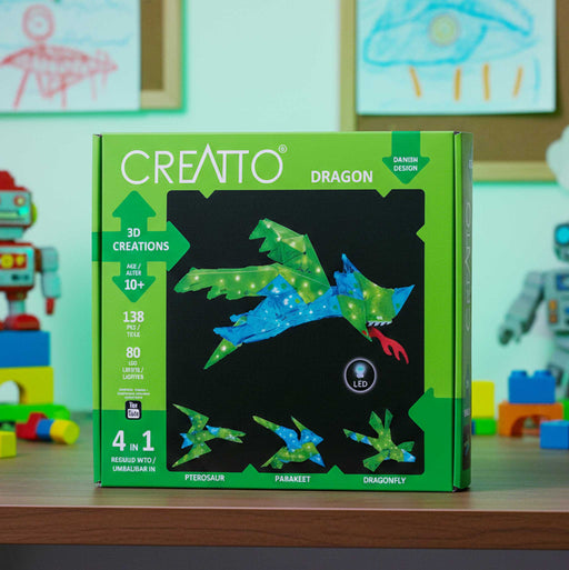 CREATTO dragon 3D puzzle packaging on a table with toys in the background