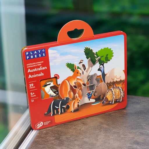 Play Press Australian Animals toy set packaging on a surface with a blurred green background