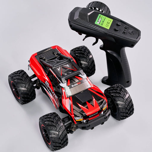 Red and black remote control toy car with a black remote on a light gray background