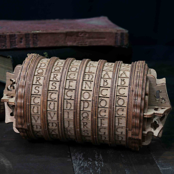 Ugears Escapewelt Cryptex Wooden letterpress wheel Wooden letter wheel with engraved letters, placed on a dark surface with an old book in the background.