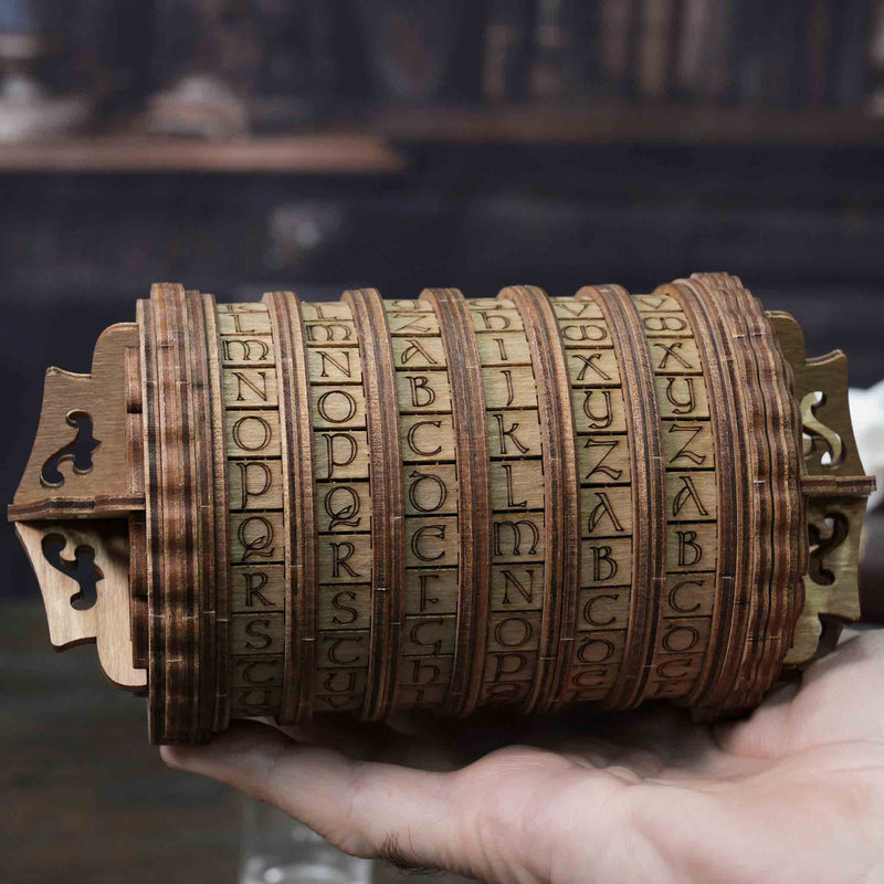 Ugears Escapewelt Cryptex Wooden letterpress wheel held in a hand with a blurred background