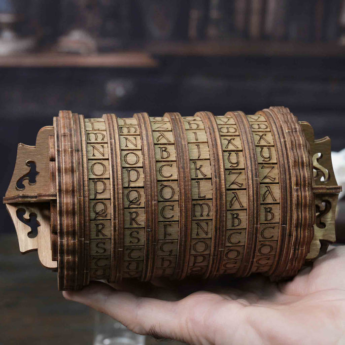 Ugears Escapewelt Cryptex Wooden letterpress wheel held in a hand with a blurred background