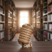 Ugears Escapewelt Cryptex Wooden letterpress wheel Wooden model of the Leaning Tower of Pisa on a table with bookshelves in the background