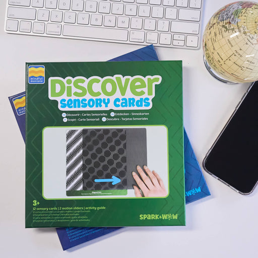 Discover Sensory Cards by Spark & Wow, shown in its green and blue retail box with a photo window displaying the cards and a hand interacting with them.