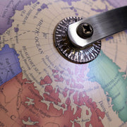 Metallic tool on a map of the Arctic region