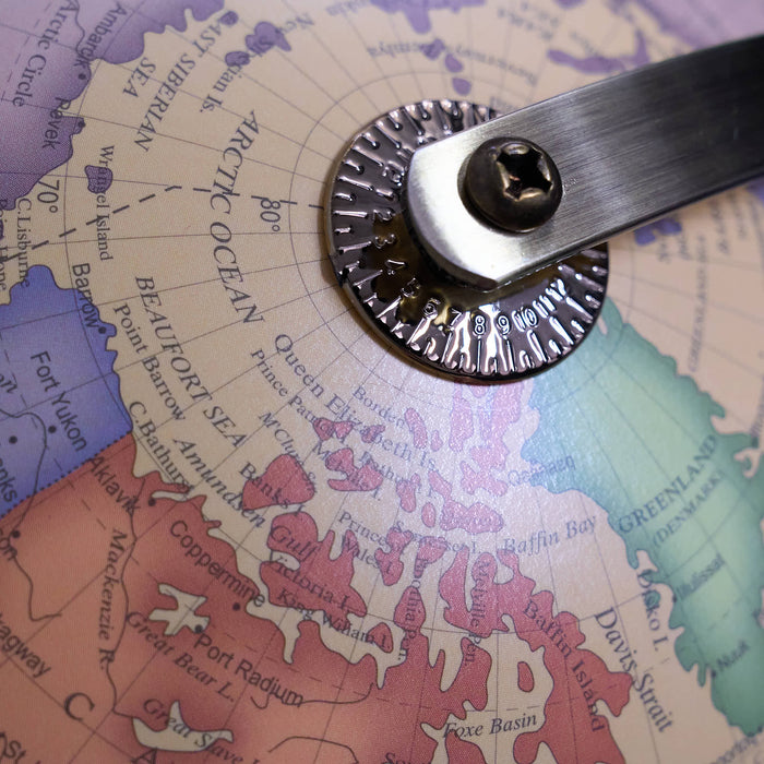 Metallic tool on a map of the Arctic region