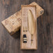 Feather pen set with ink bottle in a decorative box on a wooden surface