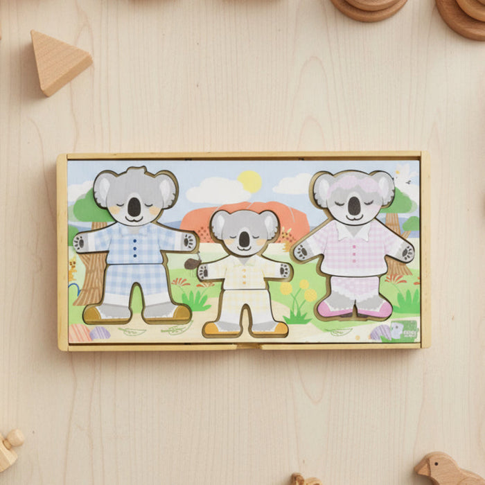 Wooden puzzle box with cartoon koalas on a wooden surface