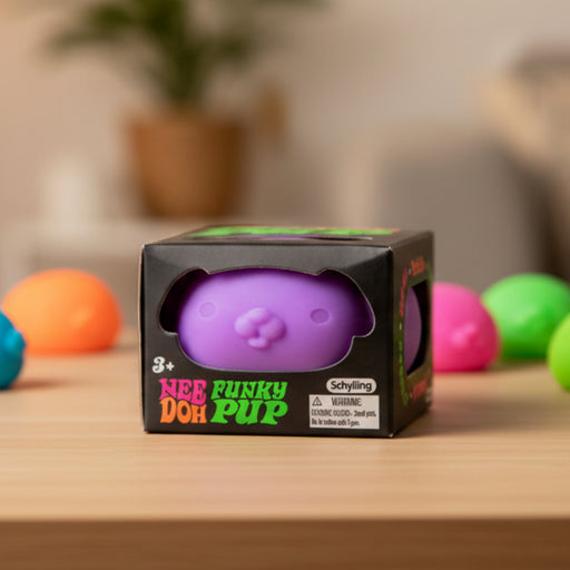 Purple 'Funky Doh Pup' toy in packaging on a wooden surface with colorful balls in the background.