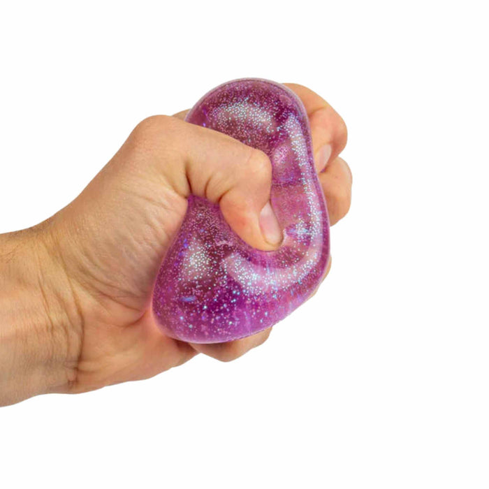 Hand holding a purple glittery stress ball against a white background