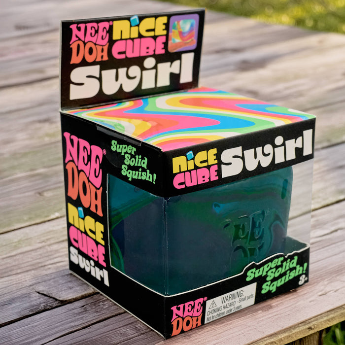 Box of Nee Doh Cube Swirl on a wooden surface