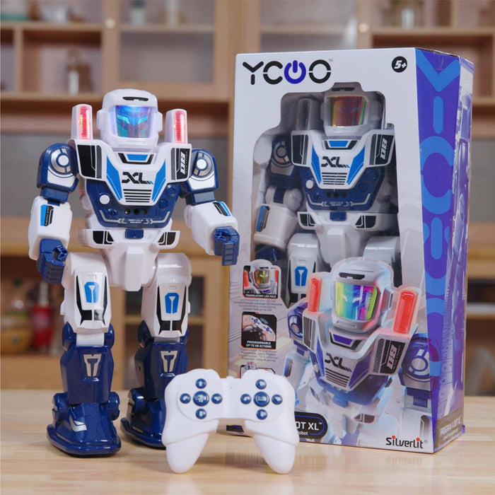 Toy robot with controller and packaging on a wooden surface