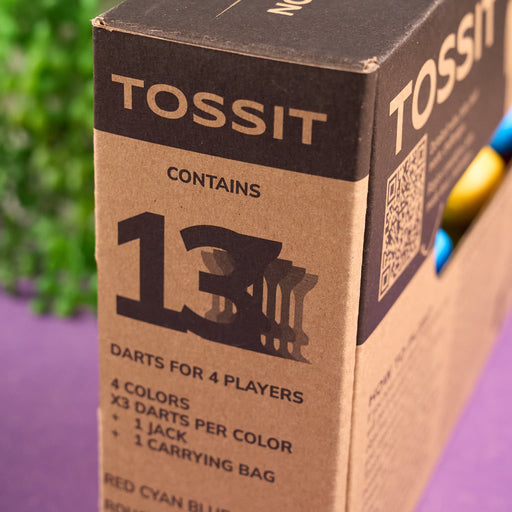 Cardboard box with 'TOSSIT' branding and product details on a purple surface.