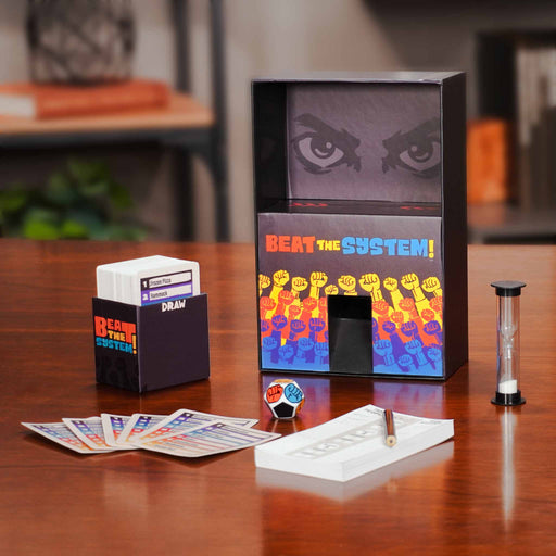 Board game components including cards, a box, and a timer on a wooden table.