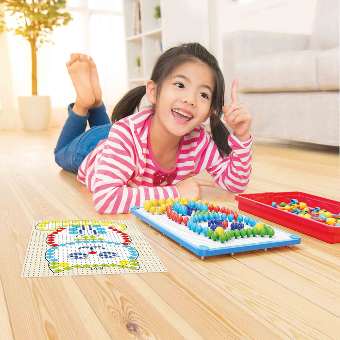 Child playing with a colorful board game on a wooden floor