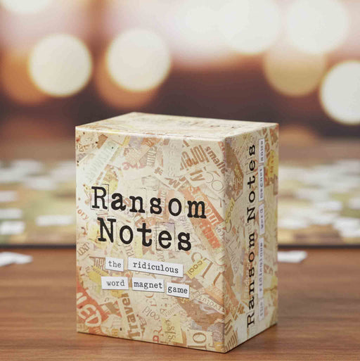 Box of 'Ransom Notes' game on a wooden surface with blurred background