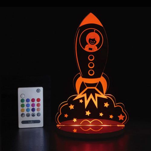A colorful LED night light designed as a rocket ship with a remote control.