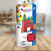 Magna-Tiles micromags travel set packaging on a wooden table with a blurred room background